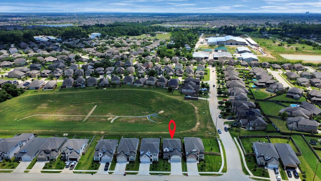 An aerial view of a spacious subdivision lot, highlighting a well-maintained yard and a fully fenced perimeter, offering both privacy and expansive outdoor space. An aerial view of a spacious subdivision lot, highlighting a well-maintained yard and a fully fenced perimeter, offering both privacy and expansive outdoor space.