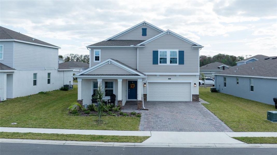 Front exterior of a new home in Providence, Davenport, FL, highlighting curb appeal (Image 2). Front exterior of a new home in Providence, Davenport, FL, highlighting curb appeal (Image 2).
