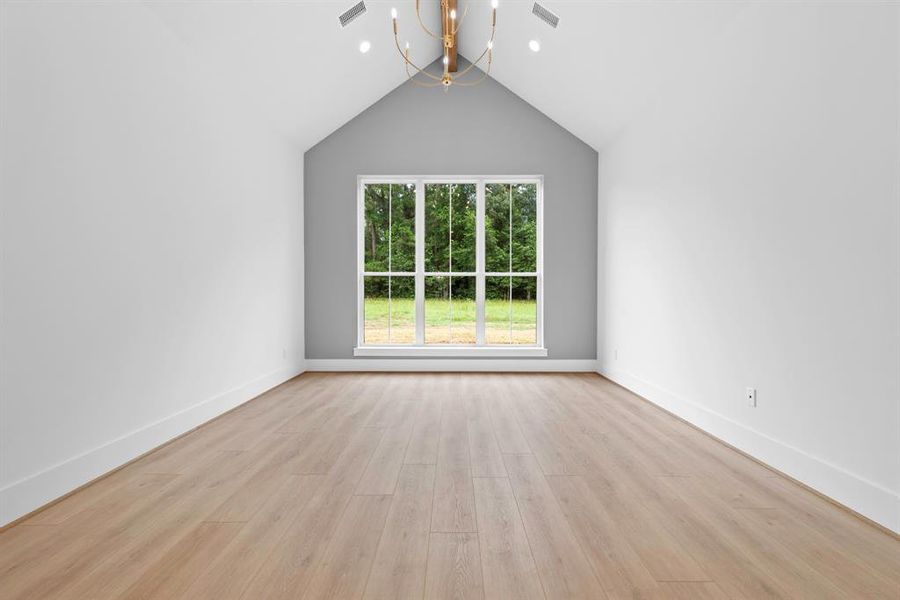 Cathedral ceiling with light wood stained beam.