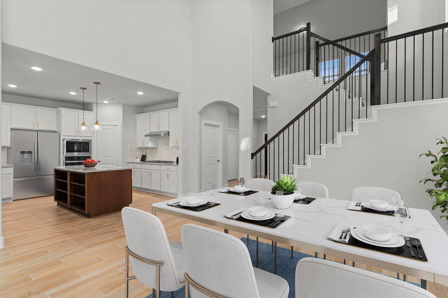 Another perspective showcases the grand staircase and two-story layout, where abundant natural light and warm flooring bring comfort and sophistication to the heart of the home. *Staged Photo* Another perspective showcases the grand staircase and two-story layout, where abundant natural light and warm flooring bring comfort and sophistication to the heart of the home. *Staged Photo*