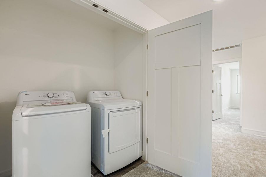 Laundry area featuring carpet and washer and clothes dryer