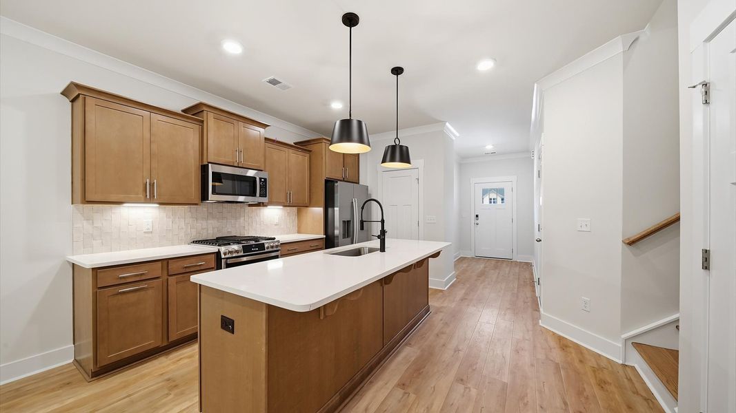 Notable kitchen space with elegant pendant lighting and a large island perfect for entertaining Notable kitchen space with elegant pendant lighting and a large island perfect for entertaining