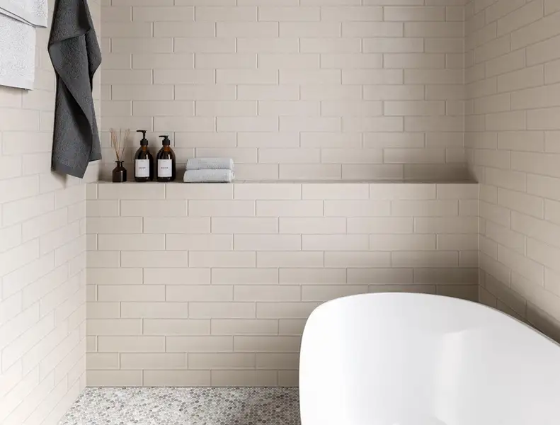 Elegant primary bathroom featuring sleek, neutral-toned tiles, a luxurious soaking tub, and stylish shelving for a spa-like retreat. Elegant primary bathroom featuring sleek, neutral-toned tiles, a luxurious soaking tub, and stylish shelving for a spa-like retreat.