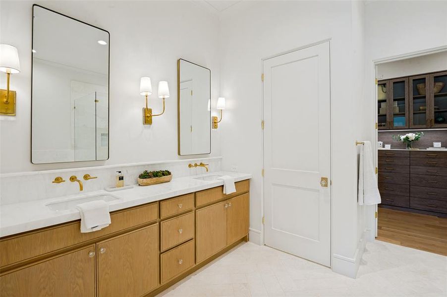 Double vanity featuring light wood cabinetry and a white countertop
