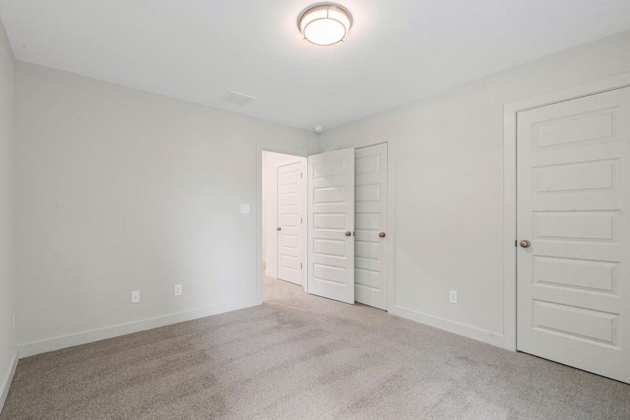 Neutral gray wall paint, recessed ceiling light, white baseboard trim, and gray carpeted flooring Neutral gray wall paint, recessed ceiling light, white baseboard trim, and gray carpeted flooring