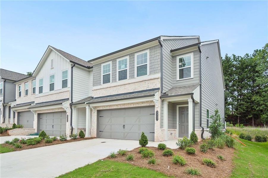 Front exterior of a new home in Eastlyn Crossing, Flowery Branch, GA, highlighting curb appeal (Image 2). Front exterior of a new home in Eastlyn Crossing, Flowery Branch, GA, highlighting curb appeal (Image 2).