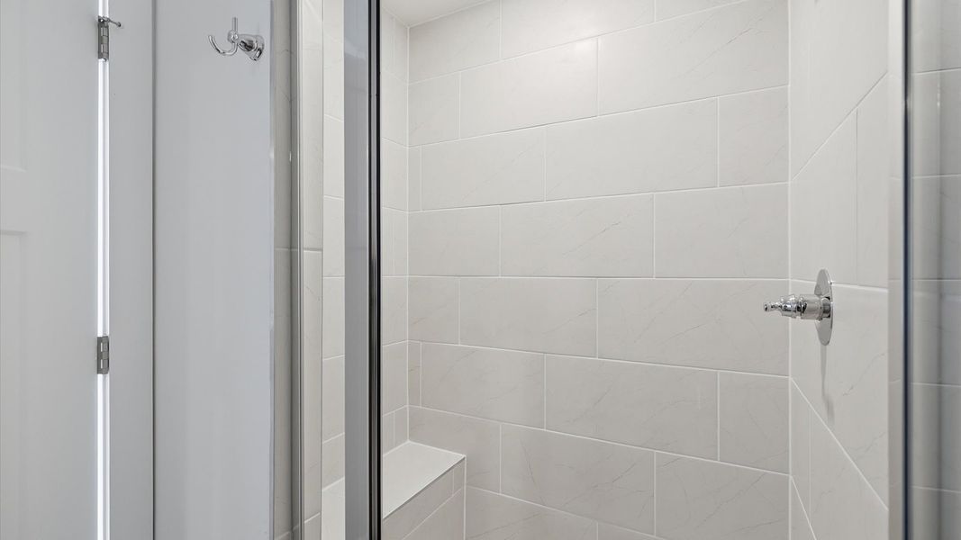 Sophisticated primary bathroom with expansive walk-in shower and polished hardware located at Barton Hollow