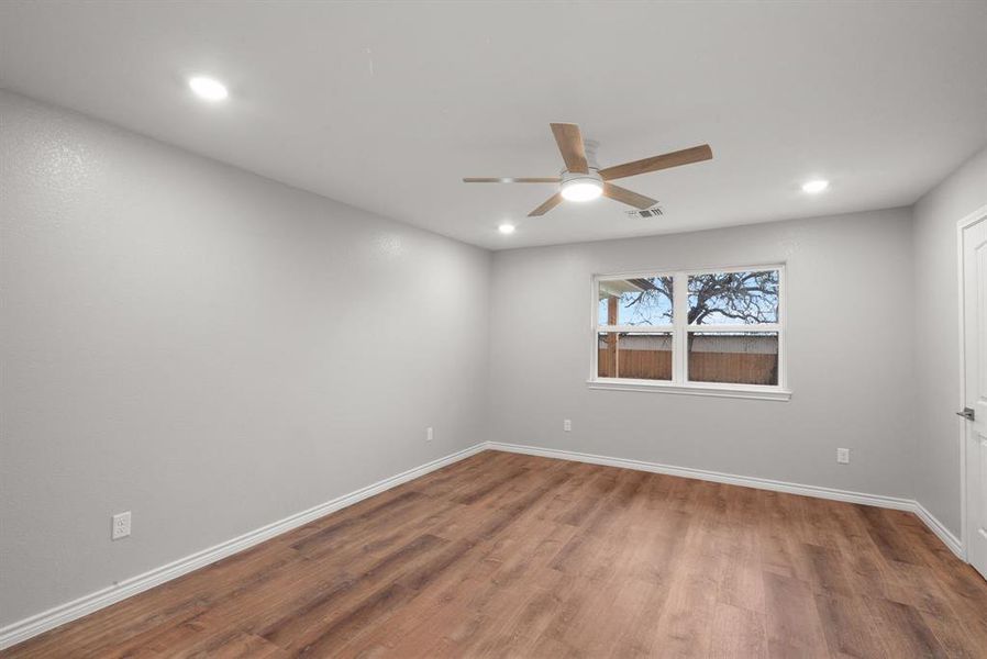 Spare room with wood-type flooring and ceiling fan Spare room with wood-type flooring and ceiling fan