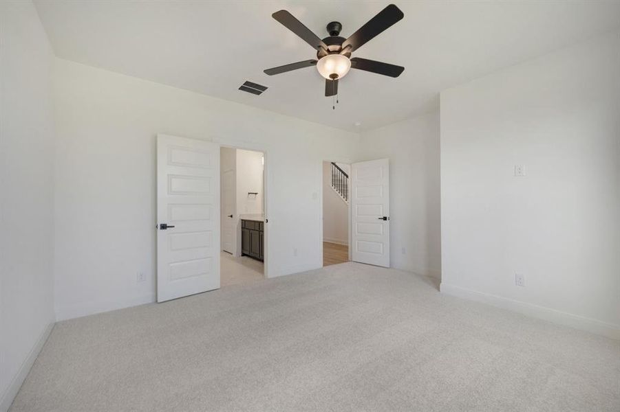Spacious room featuring light-colored carpeting and crisp white walls