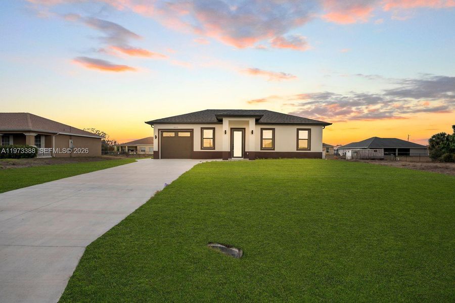 Front exterior of a new home in , Lehigh Acres, FL, highlighting curb appeal (Image 21).