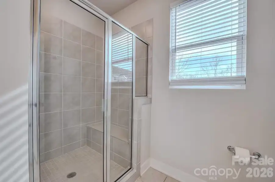The bright and modern primary bathroom features a spacious vanity with ample counter space and a walk-in shower, offering both style and everyday functionality. The bright and modern primary bathroom features a spacious vanity with ample counter space and a walk-in shower, offering both style and everyday functionality.