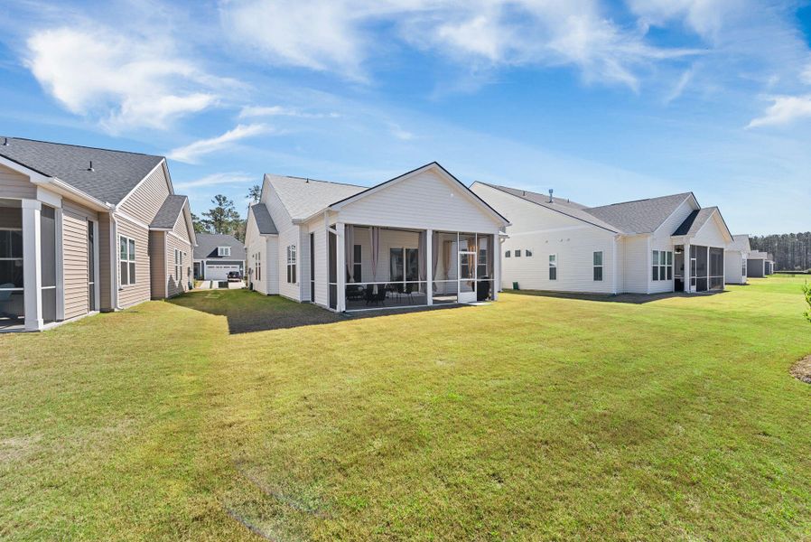 Exterior details and patio area of a home in Summerwind Crossing at Lakes of Cane Bay, Summerville (Image 28).