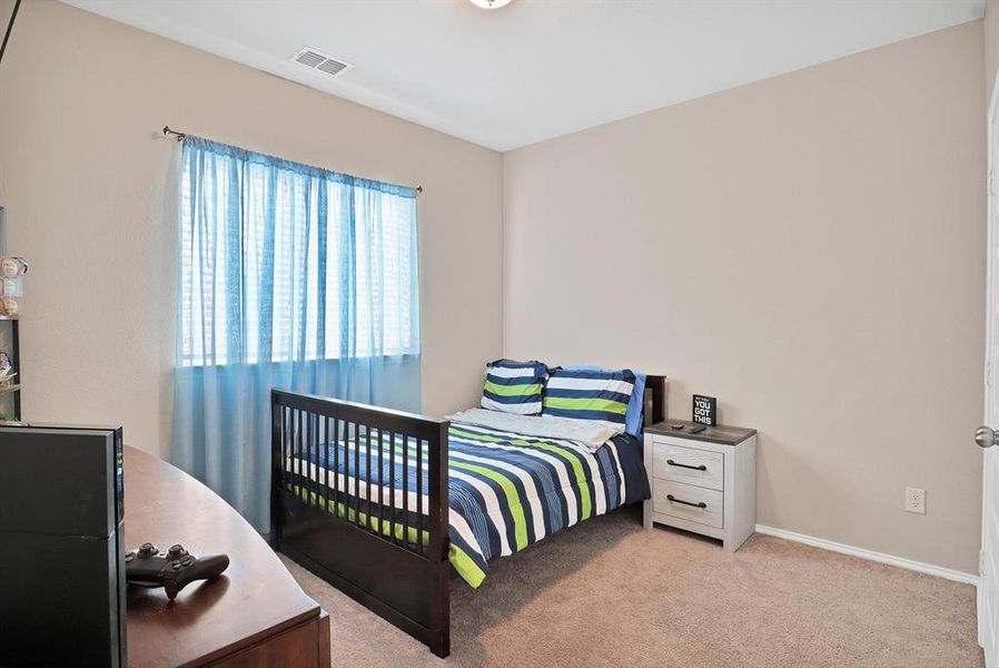 Bedroom featuring light colored carpet