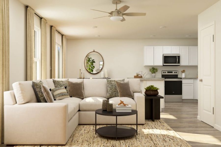 A living room with a white couch and a white table.