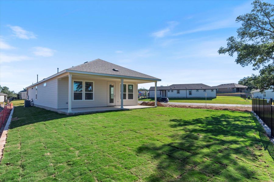 Back of house with a patio and a shingled roof