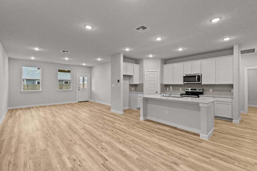 A large kitchen with white cabinets.