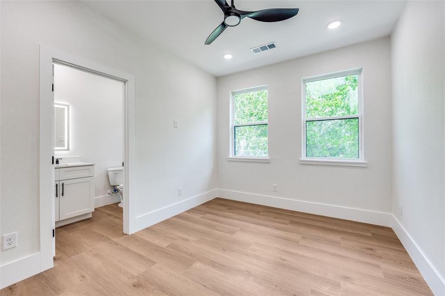 Unfurnished bedroom featuring light wood-style flooring, ensuite bathroom, recessed lighting, and ceiling fan Unfurnished bedroom featuring light wood-style flooring, ensuite bathroom, recessed lighting, and ceiling fan