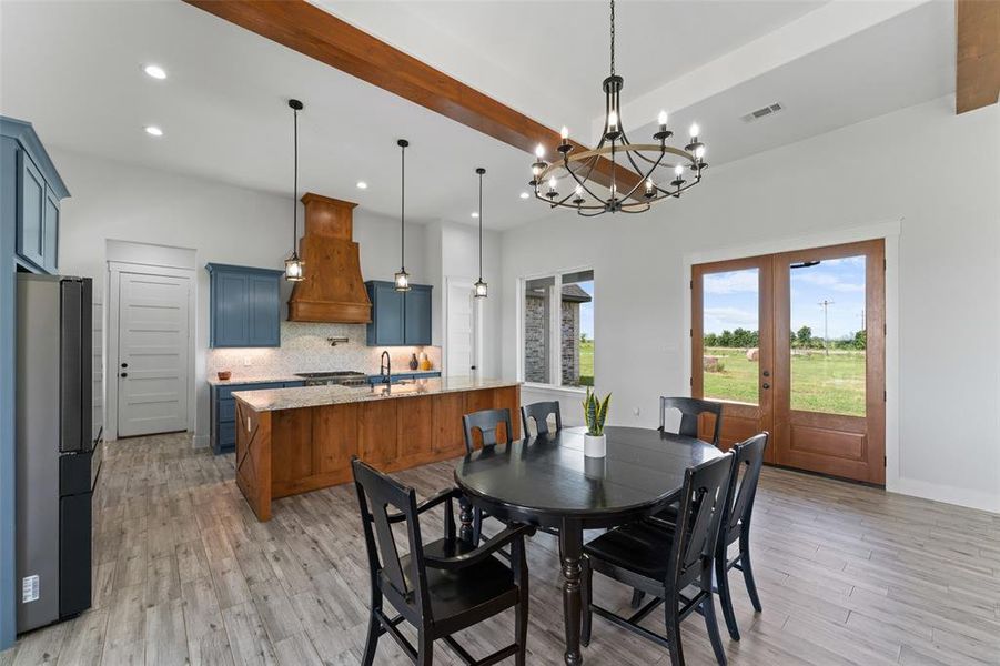 Open-concept living area featuring a kitchen with two-tone cabinetry and a substantial island