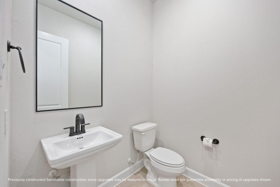 This powder bath may be petite, but it’s polished to perfection. With sleek fixtures and a splash of charm, it’s the kind of space guests will remember.