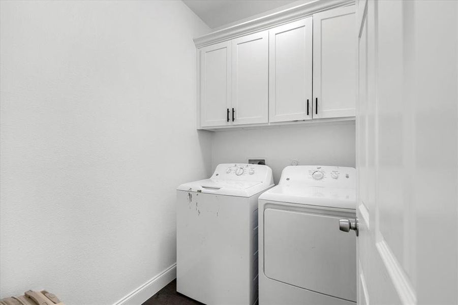 Laundry area featuring cabinet space and separate washer and dryer Laundry area featuring cabinet space and separate washer and dryer