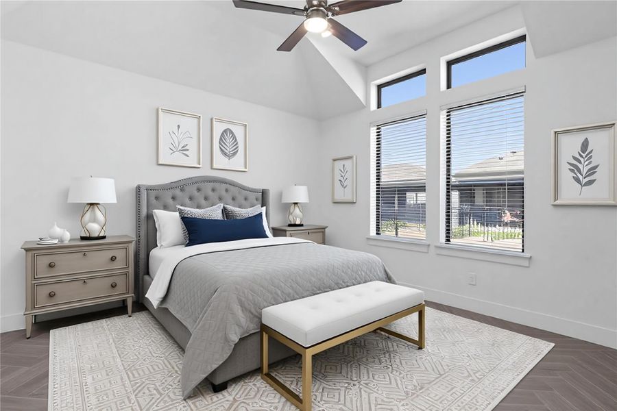 Relax and unwind after a long day in this impressive primary suite! This generously sized room offers gorgeous tile  flooring, neutral-toned paint, high sloped ceilings with a ceiling fan, and large windows for added comfort and tranquility. *Virtually Staged