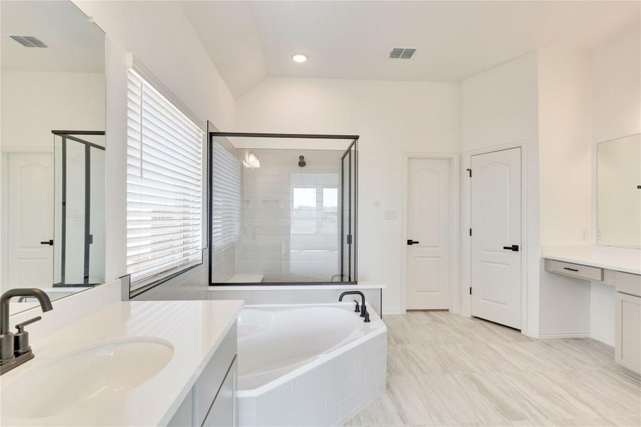 Bathroom featuring a shower stall, vanity, a garden tub, and recessed lighting