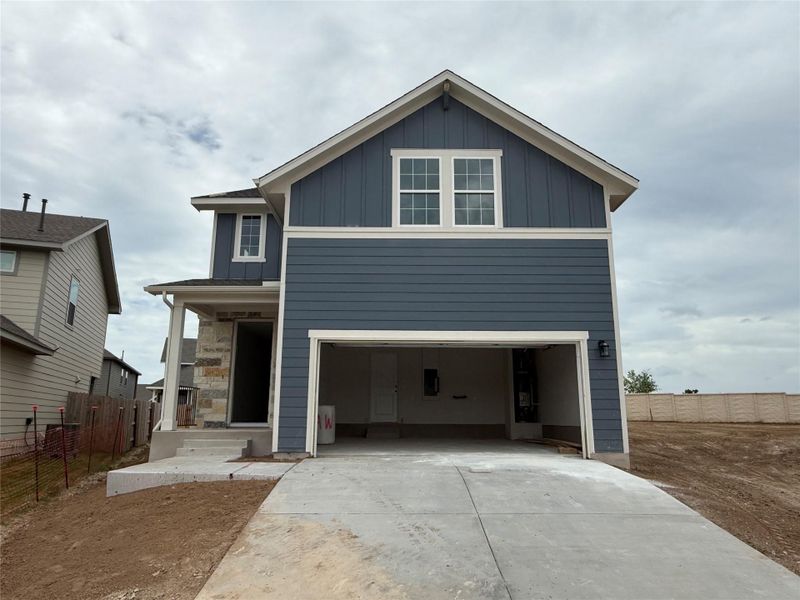 Front exterior of a new home in Cannon Ranch 40s, Dripping Springs, TX, highlighting curb appeal (Image 2). Front exterior of a new home in Cannon Ranch 40s, Dripping Springs, TX, highlighting curb appeal (Image 2).