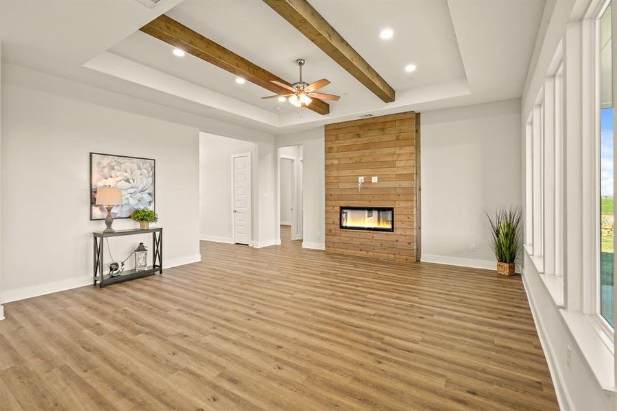 This floor-to-ceiling, wood, electronic fireplace is a showstopper! Notice how the space is already wired for a TV, providing the perfect place to enjoy a family movie.