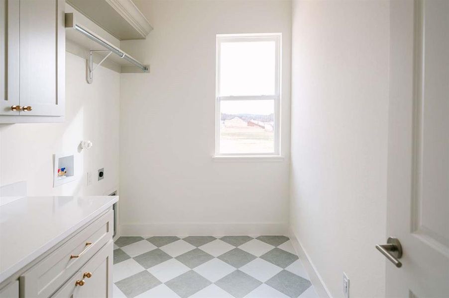 Laundry area featuring hookup for an electric dryer, washer hookup, and cabinets