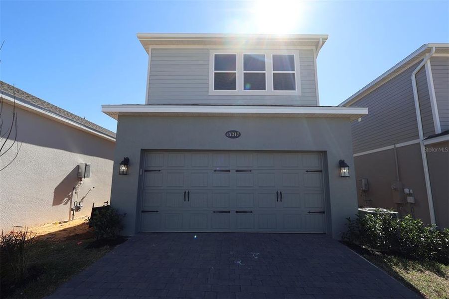 Front exterior of a new home in Lake Star at Ovation, Winter Garden, FL, highlighting curb appeal (Image 15).