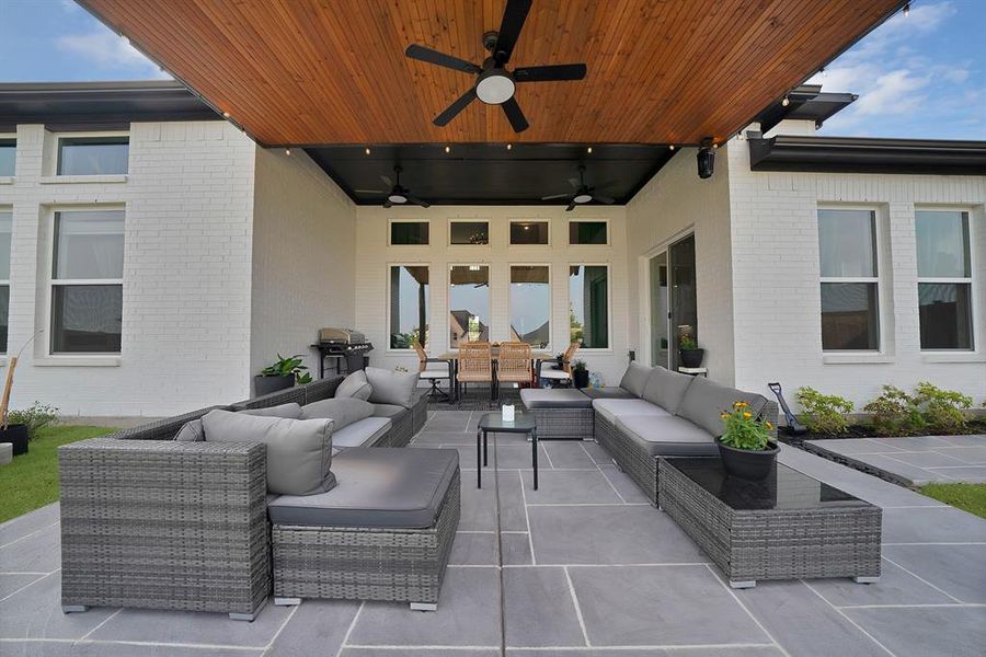 Expansive outdoor living area featuring a wood-finish ceiling with recessed lighting and ceiling fans Expansive outdoor living area featuring a wood-finish ceiling with recessed lighting and ceiling fans