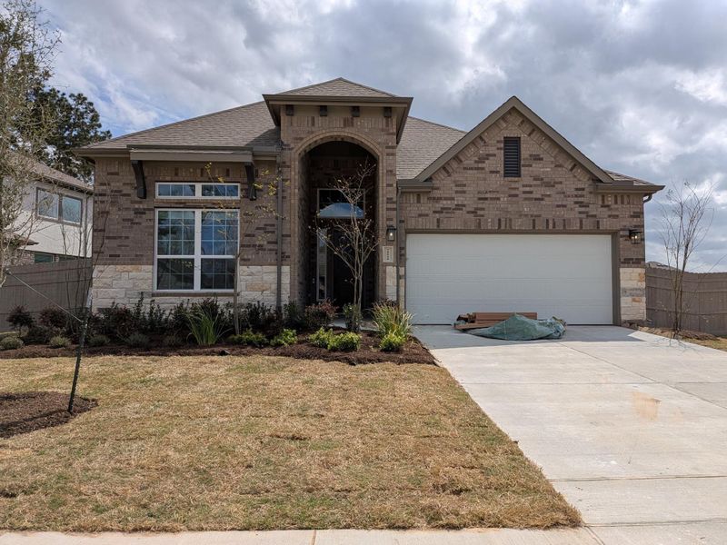 Front exterior of a new home in Artavia, Conroe, TX, highlighting curb appeal (Image 13).