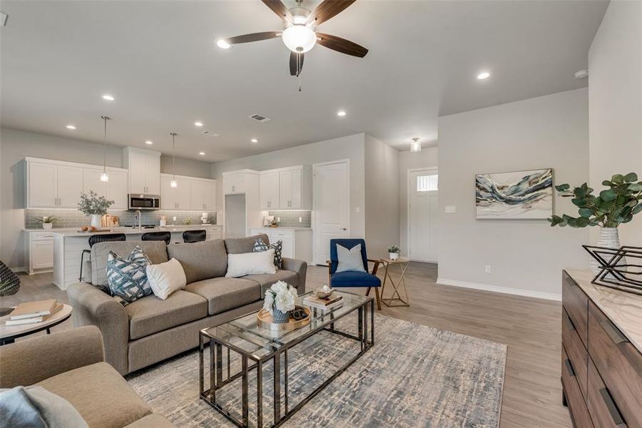 Living room featuring light hardwood / wood-style floors and ceiling fan