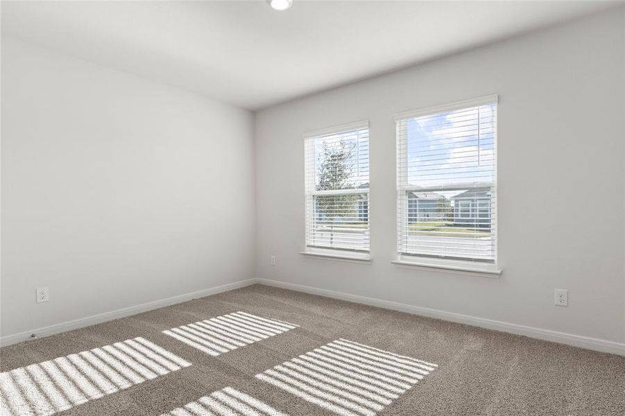 Unfurnished room featuring baseboards and carpet Unfurnished room featuring baseboards and carpet