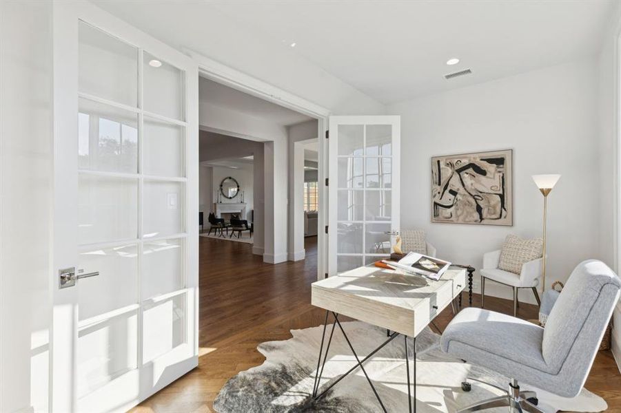 Office space with wood finished floors and recessed lighting Office space with wood finished floors and recessed lighting