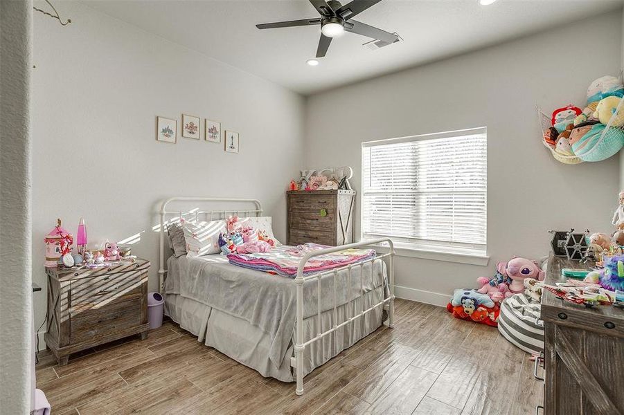 Bedroom with wood-type flooring and ceiling fan