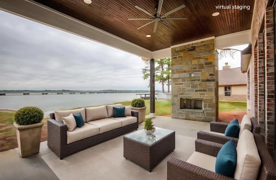 View of patio with a water view, ceiling fan, and an outdoor living space with a fireplace View of patio with a water view, ceiling fan, and an outdoor living space with a fireplace