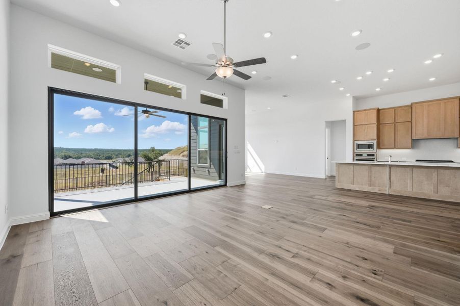 Unfurnished living room with recessed lighting, light wood-style flooring, and a ceiling fan