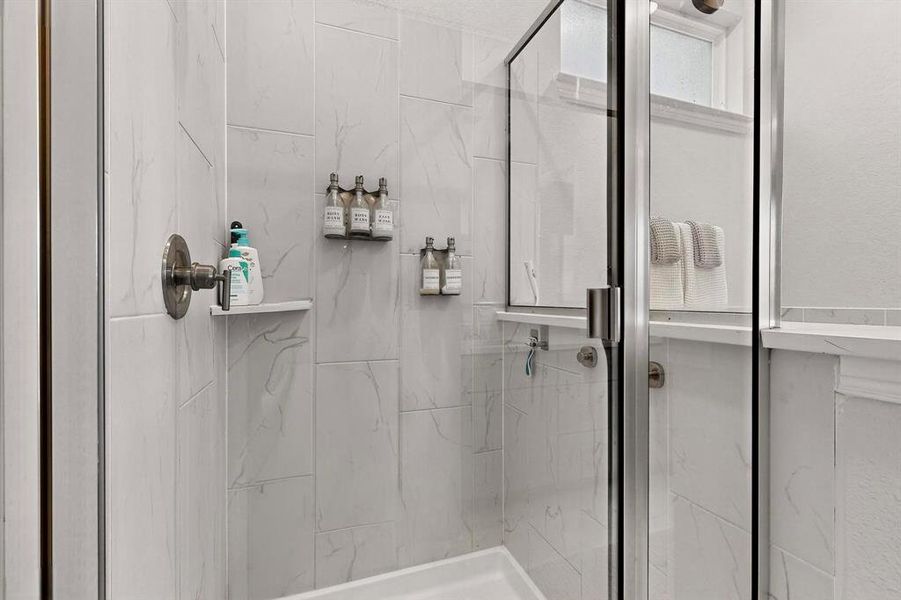 Full bath with a marble finish shower Full bath with a marble finish shower