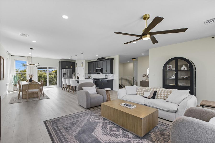 Living area featuring a ceiling fan, light wood-style floors, and recessed lighting