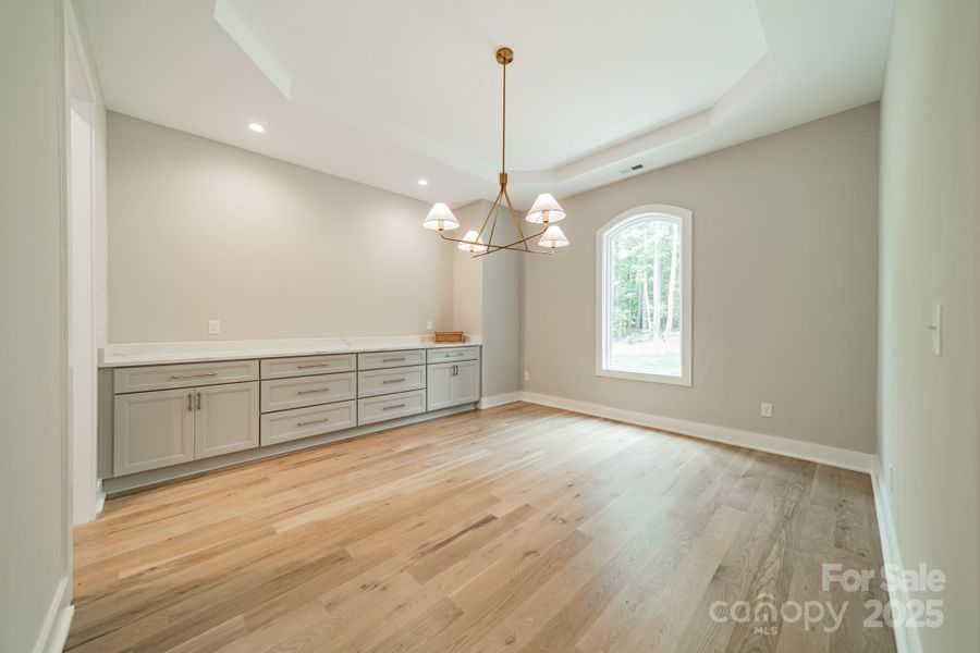 Entertain in Style in the grand Dining Room with built-in Cabinetry and Quartz Countertops
