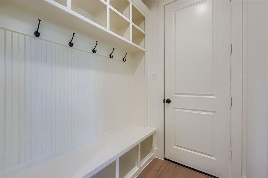 Mudroom with light wood-style flooring