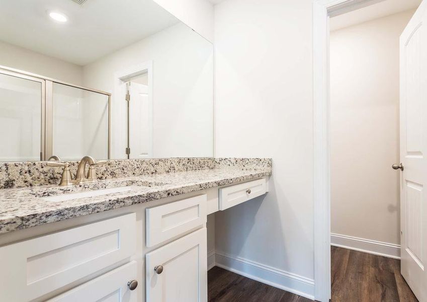 Master bathroom with oversized vanity and vinyl flooring.