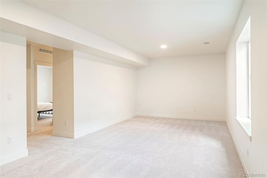 Spacious finished basement with large recreation area, ideal for a media room, gym, or additional living space in this Morrison Colorado home
