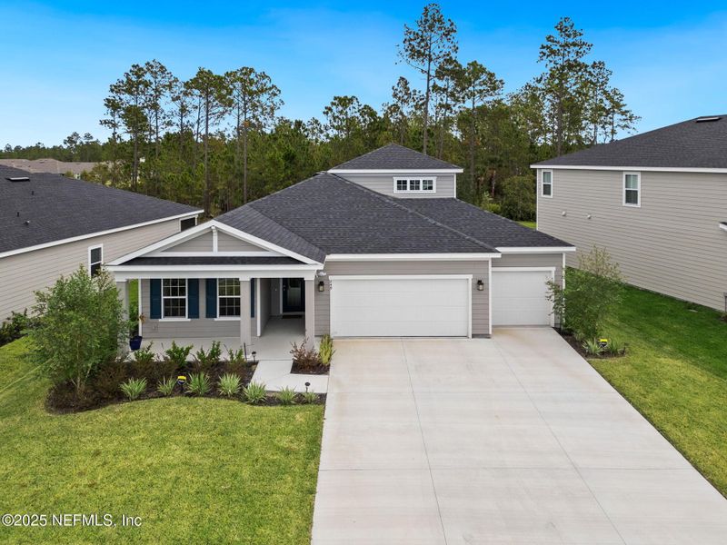 Front exterior of a new home in Seminole Palms Single-Family Homes, Palm Coast, FL, highlighting curb appeal (Image 22).