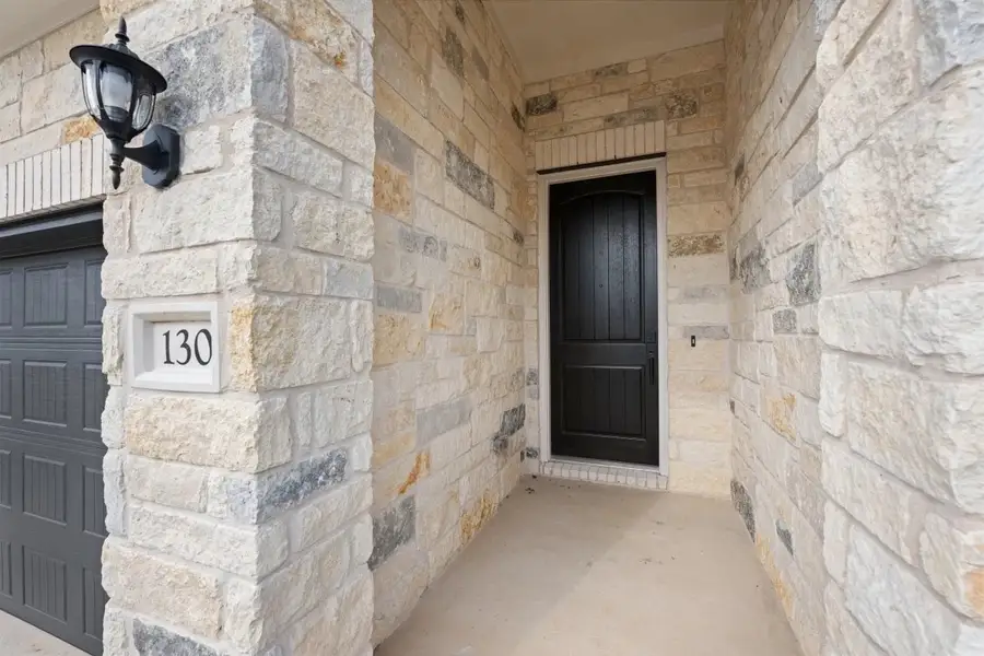 Exterior details and patio area of a home in The Colony 50s, Bastrop (Image 3).