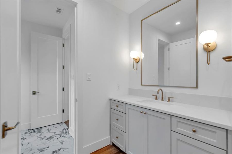 Bathroom with vanity and recessed lighting