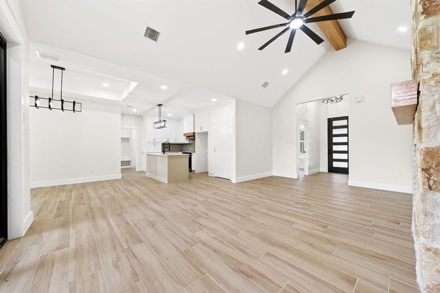 Spacious open-concept interior featuring light wood-finish flooring throughout Spacious open-concept interior featuring light wood-finish flooring throughout