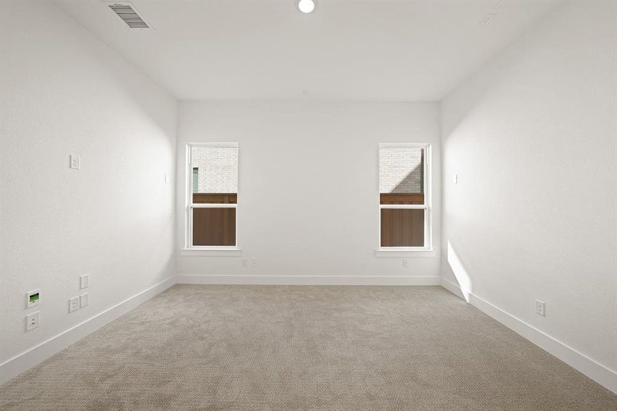 Carpeted empty room with plenty of natural light Carpeted empty room with plenty of natural light