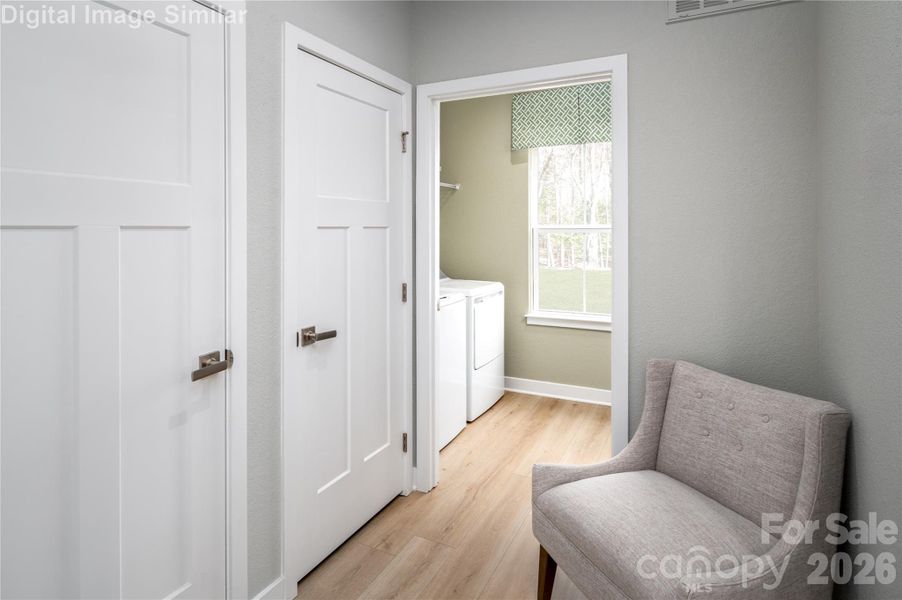 Step in through the family entrance and discover a cozy corner perfect for unwinding with a book while the laundry hums away. Tucked behind sleek, discreet doors lies a hidden gem—extra storage and a coat closet that keeps clutter out of sight and calm vibes front and center.